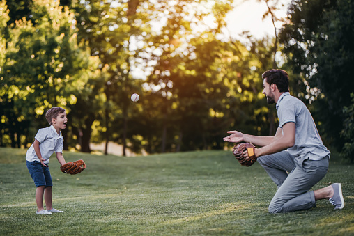 Shot of a young baseball player pitching the ball during a game outdoors