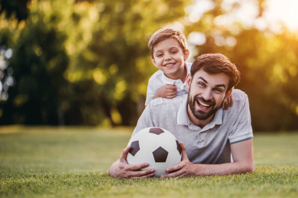 istock Dad with son playing football, soccer 997710300