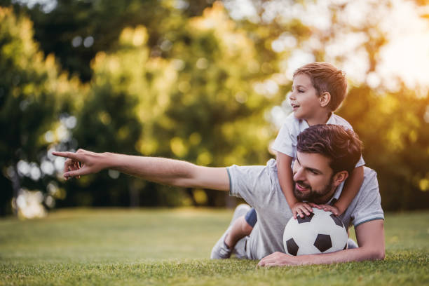 istock Dad with son playing football, soccer 997710334