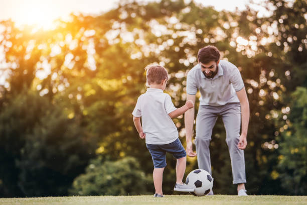 istock Dad with son playing football, soccer 997710474