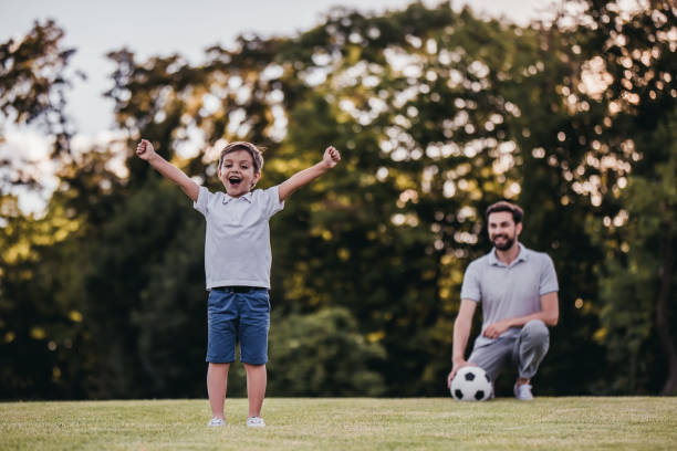istock Dad with son playing football, soccer 997710630