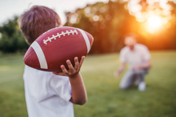Dad with son playing American football