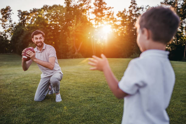 istock Dad with son playing American football 997710818