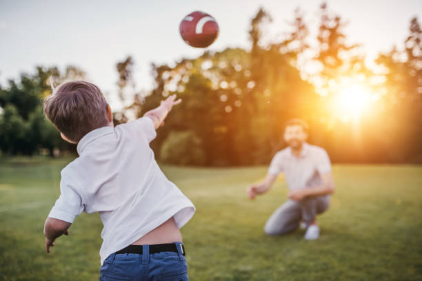 istock Dad with son playing American football 997710852