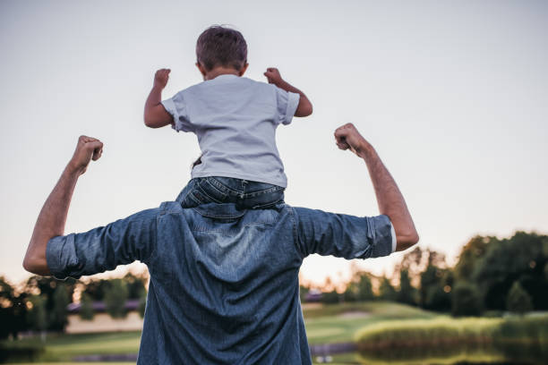 Dad and son outdoors Dad and son having fun outdoors. strength stock pictures, royalty-free photos & images