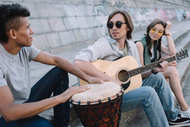 istock Multiracial young people performing musical concert on street 997711096