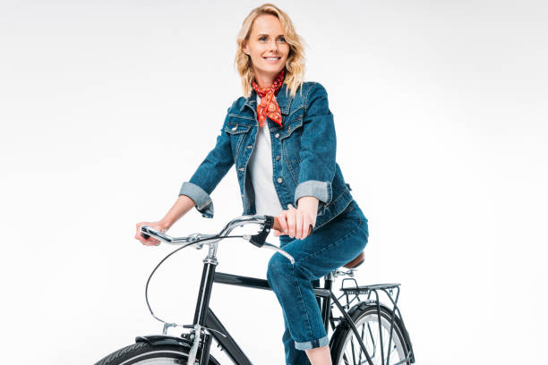 istock attractive woman riding bicycle isolated on white 997723314