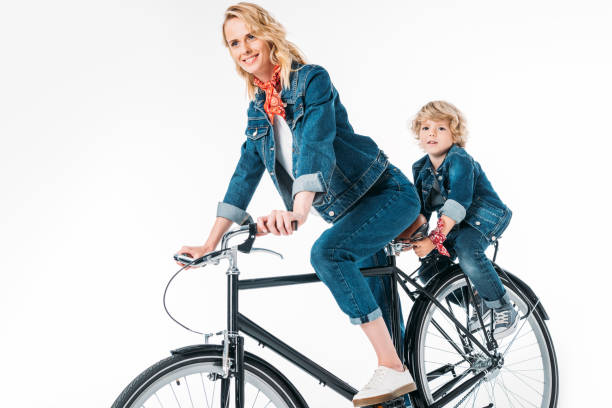 istock mother and son riding bicycle isolated on white 997724450