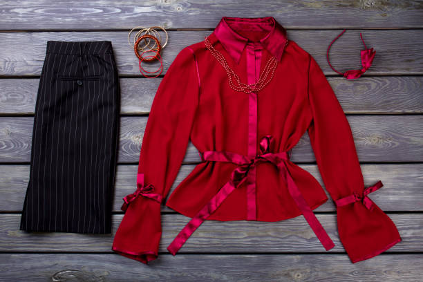istock Black trousers and red blouse, flat lay. 997725042