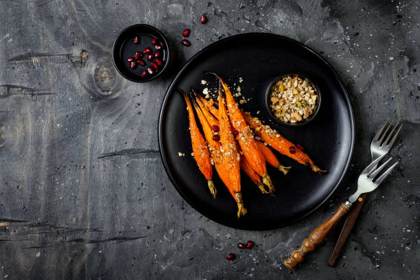 istock Roasted carrots with dukkah. Vegetarian food. Top view, flat lay, copy space 997745676