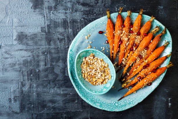 istock Roasted carrots with dukkah. Vegetarian food. Top view, flat lay, copy space 997745730