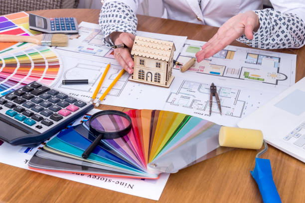 istock Female hands with house model and colour swatch 997746814