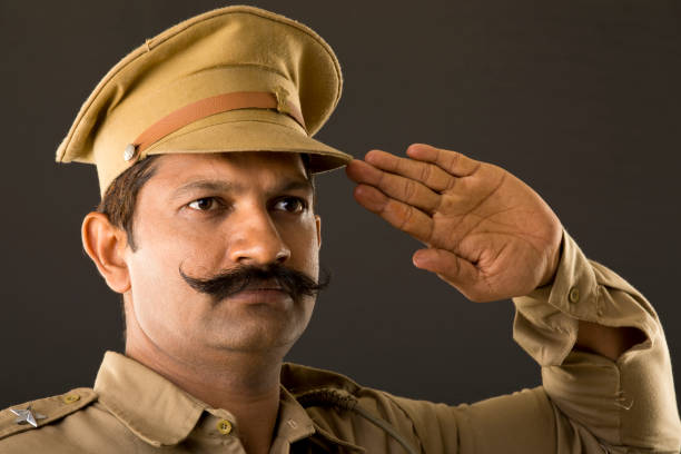istock Police officer saluting 997772116
