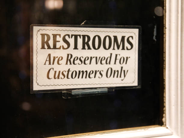 istock Restroom Reserved for Customers Patrons Only Sign in Window 997772368