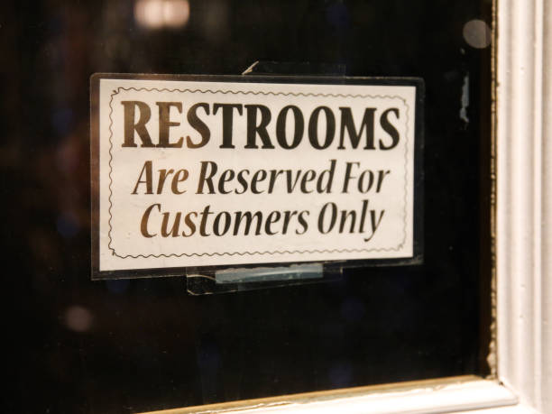 Restroom Reserved for Customers Patrons Only Sign in Window stock photo