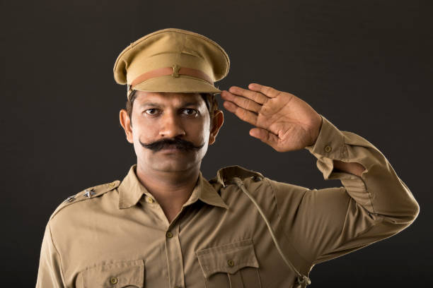 istock Police officer saluting 997772728