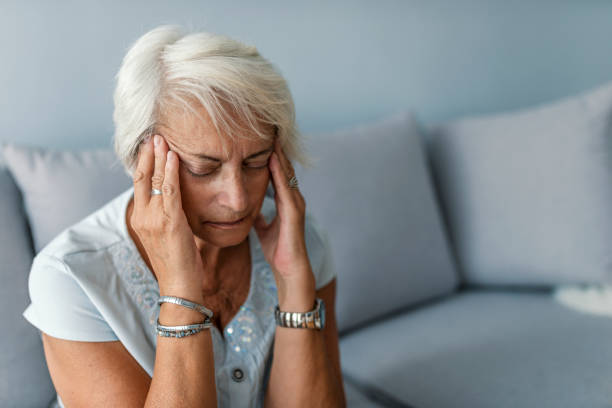 istock Senior lady with migraine touching her forehead 997779234