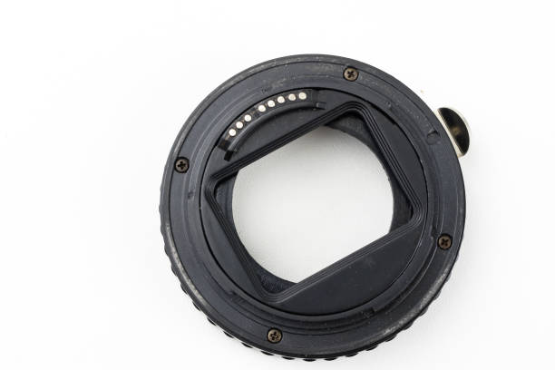 Intermediate ring for macro photography on a white table. Photo accessories for photographic shooting. White background.