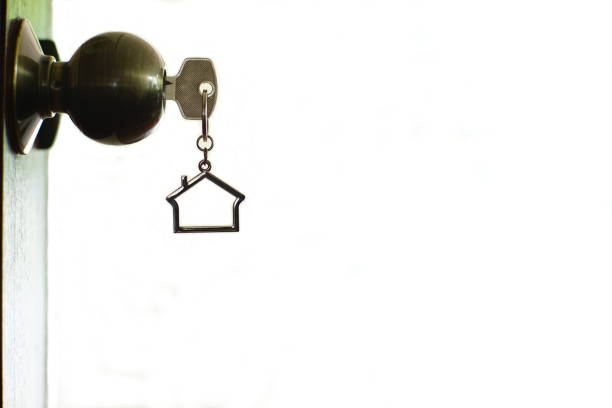 istock Home key with house keyring in keyhole, copy space, property concept 997790332