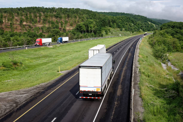 Trucks Moving Down Interstate Highway, Tractor Trailer Trucking stock photo