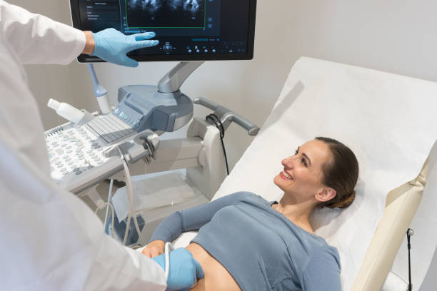 istock Woman and doctor looking at ultrasonic screen during examination 997797014