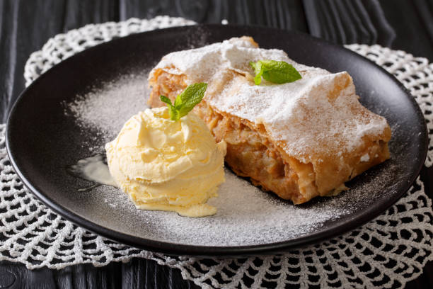 Apple strudel with vanilla ice cream close-up. Horizontal Apple strudel with vanilla ice cream on a plate close-up. Horizontal ice pie photography stock pictures, royalty-free photos & images