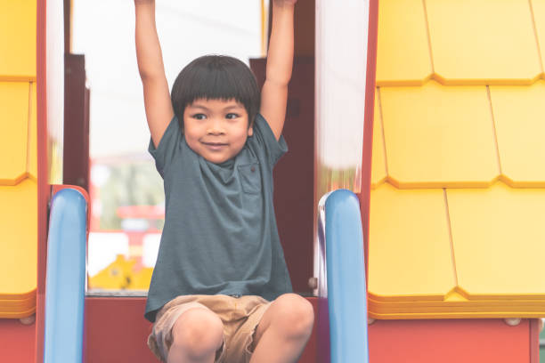 istock Boy is climbing down the playground house 997802608