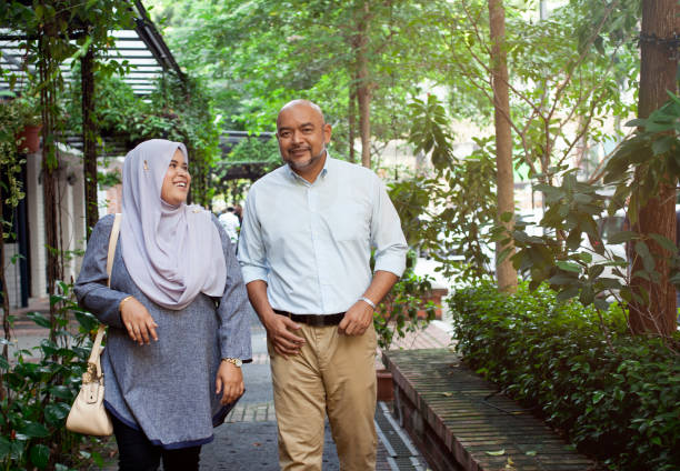 istock Malay couple walking and talking downtown 997807616
