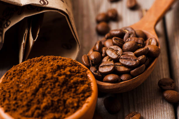 istock Fresh ground coffee beans on a wooden table. 997834266