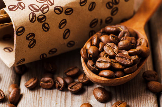 istock Fresh ground coffee beans on a wooden table. 997834488