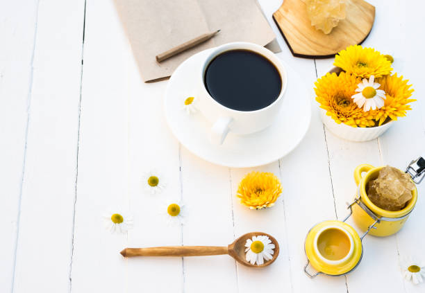 istock Cup of Coffee and Summer Calendula and Chamomile Flowers 997838432