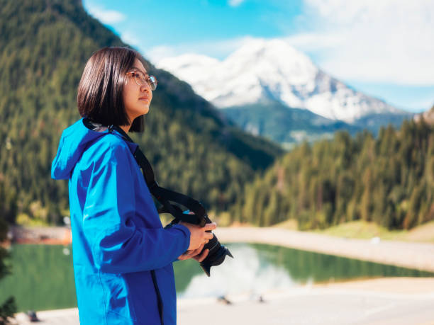 A Japanese woman take a break while photographing a wilderness area in Utah, USA.