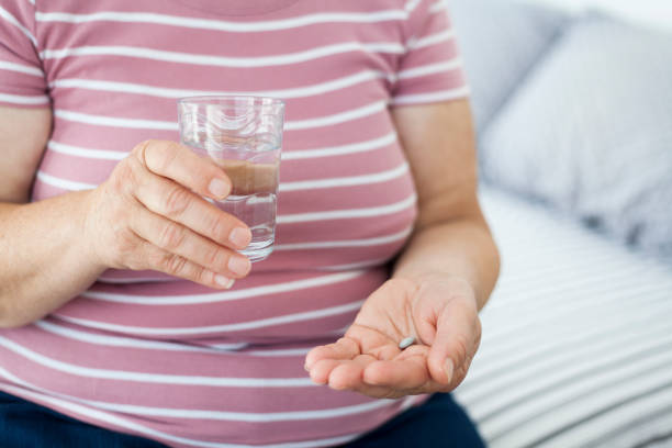 istock Senior woman taking pills 997884676