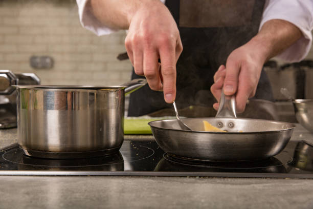 istock Chef in restaurant kitchen at stove with pan 997904820