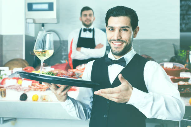istock Waiter holding tray with seafood dishes at fish restaurant again 997907922