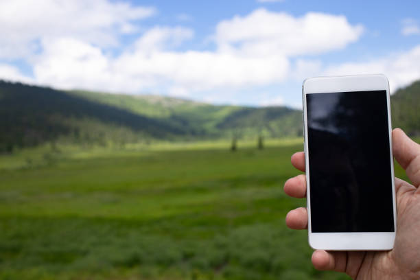 istock The traveler uses a smart phone in the mountains 997910608
