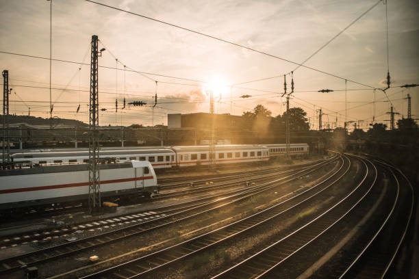 istock Railroad tracks with trains at sunset 997921162