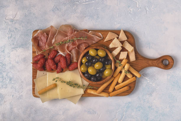 istock Sausage olives prosciutto cheese bread sticks wine 997921746