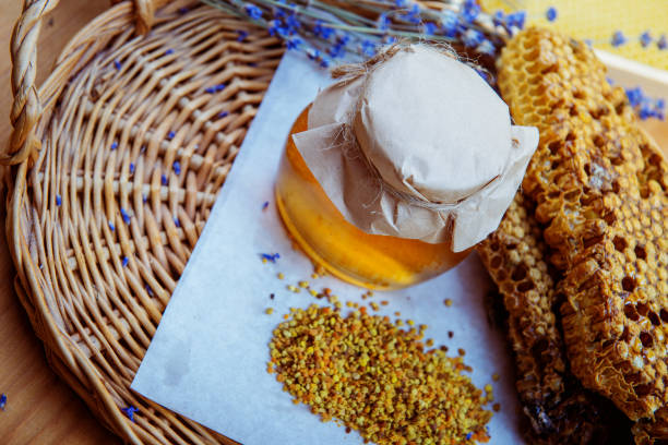 istock Honeycomb, glass pot with honey 997922404