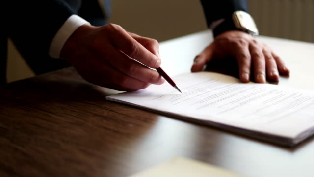 Close up business man signing contract