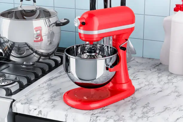 Red stand kitchen mixer on the kitchen table. 3D rendering