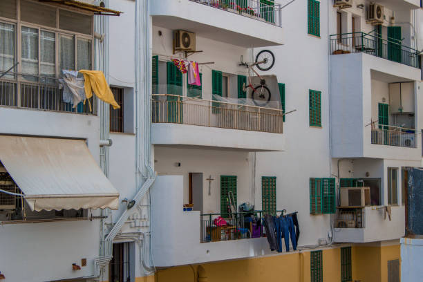 Apartment building in Palma, Mallorca Spain with clothes and bikes hanging from the balconies.