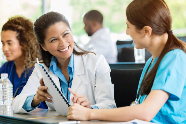 istock Healthcare conference attendees review conference materials 997931256
