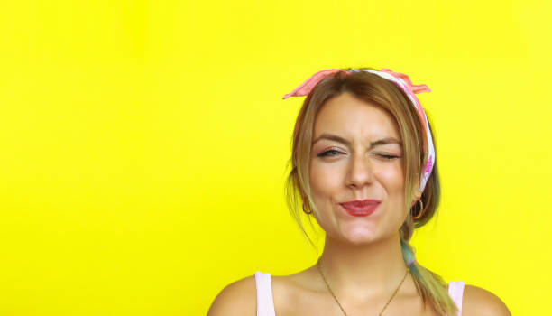 istock Young beautiful woman looks at the camera and winks 997941744