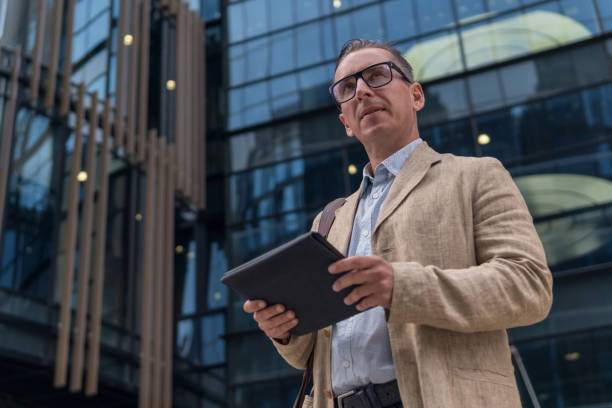 istock Businessman in casual wear with tablet pc 997942468
