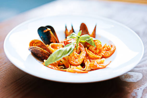 istock Pasta with mussels and arugula lying in white plate 997948766