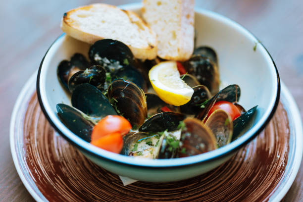 istock Selective focus of mussels with lemon and cherry tomatoes 997948830