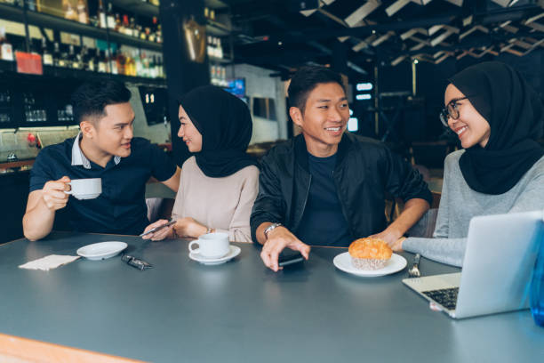 istock Young Malaysian couples are talking and drinking coffee in a cafeteria 997948908