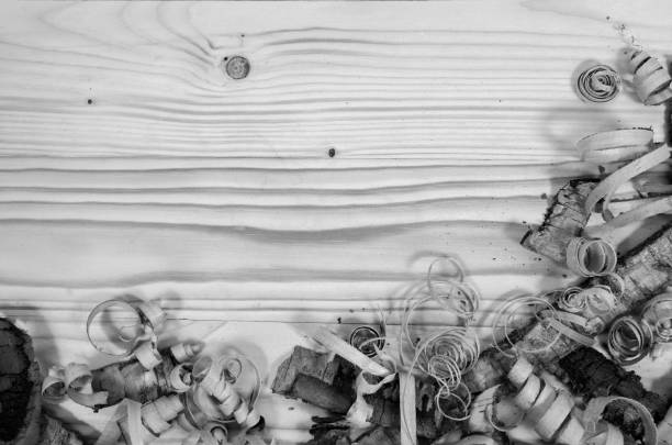 Wooden shavings on a wooden table in black and white.