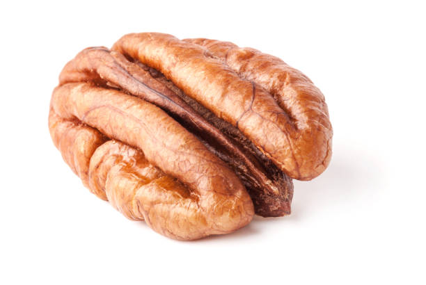 istock Peeled pecan nuts closeup, isolated on white background 997949248